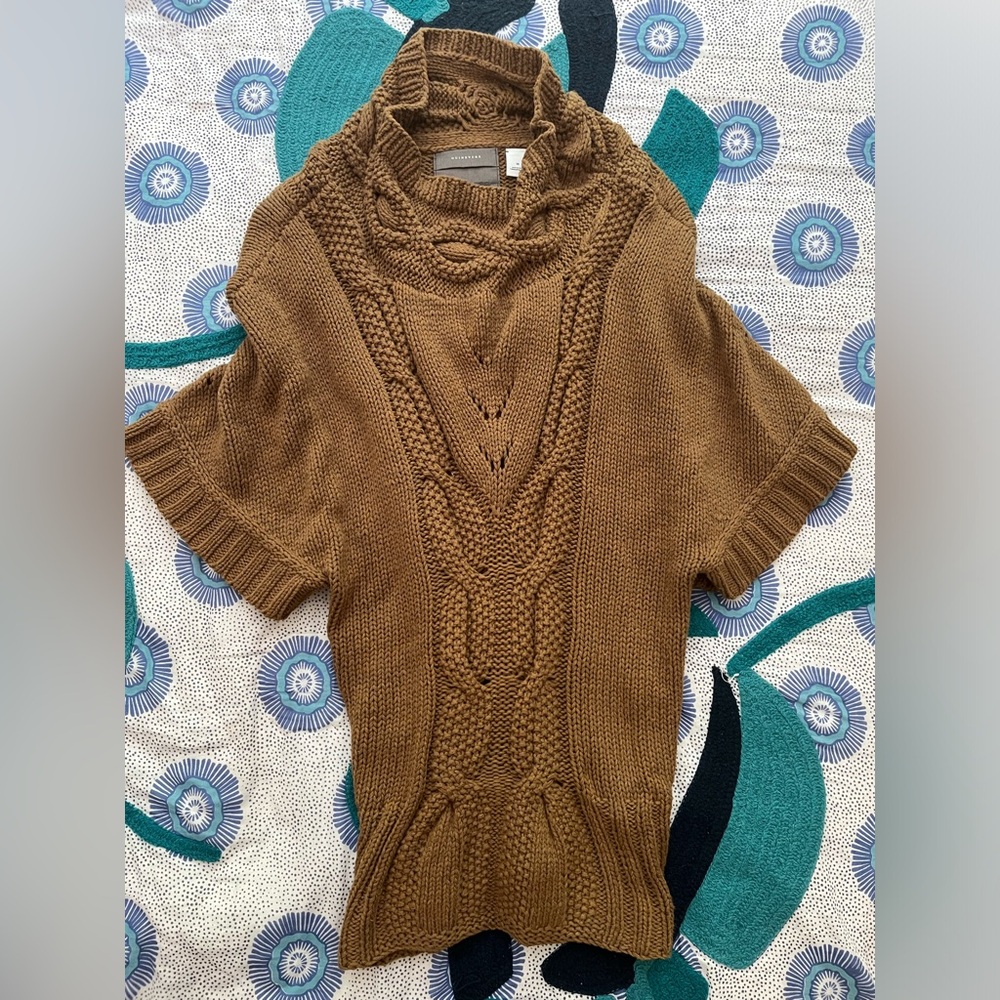 Brown sweater with elbow length sleeves.